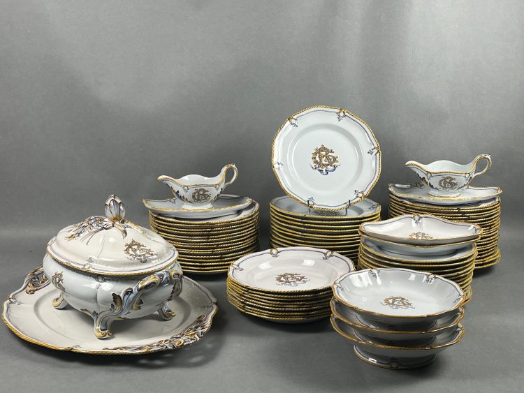 Emile GALLE (Lorraine). Important service de table, modèle « Cordelière » aux chiffres de ses parents GR (Gallé-Reinemer) et de la devise « En bon espoir » se composant d’une grande soupière et de son plat de présentation, de 2 saucières, de 2 raviers, de 3 assiettes à gâteaux sur talon, 12 assiettes à dessert, 50 assiettes plates et 9 assiettes creuses. Quelques rares accidents. Avec un inventaire domestique manuscrit au nom de Madame Veuve Paul Perdrizet, avenue de la Garenne à Nancy, daté de 1958. Le musée de l'Ecole de Nancy en conserve quelques pièces : une coupe, un plat rond, une jatte, un pot à crème couvert, et une tasse et sa soucoupe (inv. VG 82.1, JB 81.50 et 83.12, P 72.3, PT 79). Voir Françoise-Thérèse Charpentier et Philippe Husson, La Céramique de Gallé conservée au Musée de l'Ecole de Nancy, 1984, p. 50. Provenance : collection Geneviève Aubry (1948-2025), Rosières-aux-Salines.Emile GALLE (Lorraine). Important service de table, modèle « Cordelière » aux chiffres de ses parents GR (Gallé-Reinemer) et de la devise « En bon espoir » se composant d’une grande soupière et de son plat de présentation, de 2 saucières, de 2 raviers, de 3 assiettes à gâteaux sur talon, 12 assiettes à dessert, 50 assiettes plates et 9 assiettes creuses. Quelques rares accidents. Avec un inventaire domestique manuscrit au nom de Madame Veuve Paul Perdrizet, avenue de la Garenne à Nancy, daté de 1958. Le musée de l'Ecole de Nancy en conserve quelques pièces : une coupe, un plat rond, une jatte, un pot à crème couvert, et une tasse et sa soucoupe (inv. VG 82.1, JB 81.50 et 83.12, P 72.3, PT 79). Voir Françoise-Thérèse Charpentier et Philippe Husson, La Céramique de Gallé conservée au Musée de l'Ecole de Nancy, 1984, p. 50. Provenance : collection Geneviève Aubry (1948-2025), Rosières-aux-Salines.